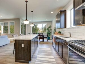 A modern remodeled kitchen featuring a large island, connected to a living room in El Reno, OK