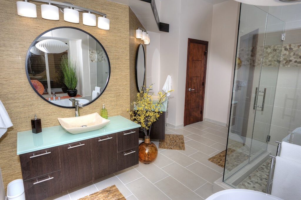Oklahoma City bathroom remodel with modern floating vanity and tile floor, and beige walpaper upgraded doors and walnut cabinetry